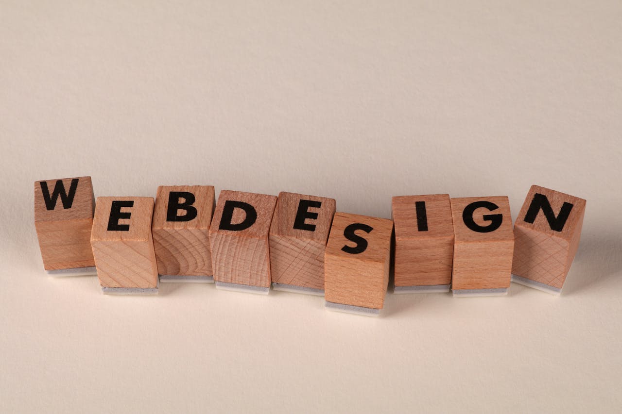 Wooden blocks spelling web design creatively showcase digital design concept.